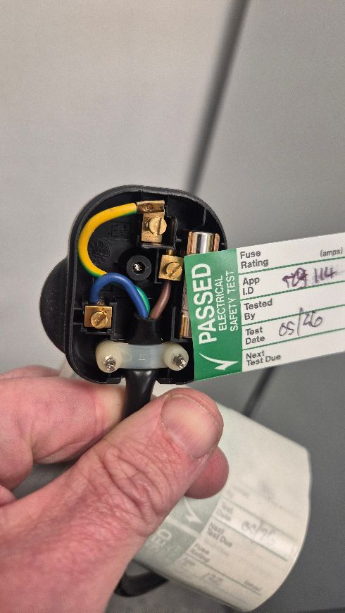 PAT tested plug showing a green PASSED electrical safety label