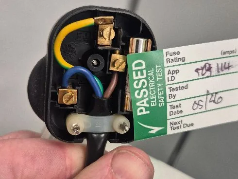 PAT tested plug showing a green PASSED electrical safety label